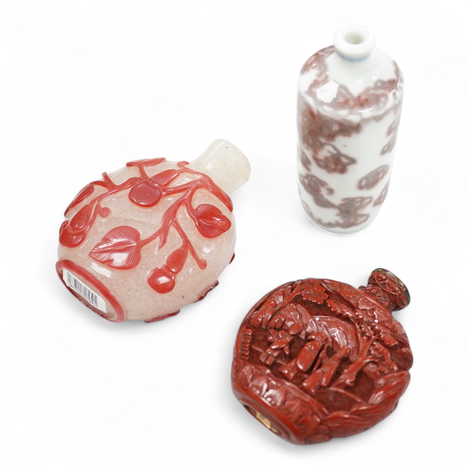 A Chinese cinnabar lacquer snuff bottle, a glass overlay snuff bottle and an underglaze copper red snuff bottle-9cm high (3)